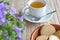 Cup herbal tea Cookies Flowers on bamboo tabletop