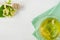 Cup of herbal tea with fresh branch linden blossom on a white wooden background.