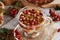 A cup of herbal tea with fresh hawthorn berries harvested in autumn