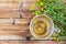 Cup of herbal tea from Hypericum - St. John`s wort plant on wooden board table, top view. Copy space.