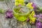 Cup of herbal tea and medicinal herbs on a wooden table. fresh thyme and immortelle. cold and flu remedy