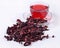 Cup of hibiscus tea and a dried petals of hibiscus