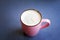 A cup of homemade hot milky coffee with empty space for text. Vivid bright colors