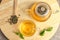 Cup of hot aromatic tea and teapot on table