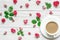 Cup of hot cappuccino or coffee with milk on white saucer with flowers composition made of pink rose flowers