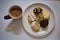 A cup of hot chocolat and doughnuts in various flavors and toppings