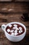 A cup of hot chocolate or cocoa with marshmallows on wooden background