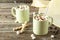 Cup of hot chocolate with marshmallows on grey wooden background