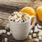 Cup of hot cocoa with chocolate orange and zest on dark wooden background. selective focus