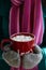 Cup of hot cocoa with marshmallow in woman\'s hands