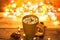 Cup of hot cocoa with marshmallows and chocolate on wooden background with beautiful Christmas lights.