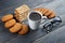 Cup of hot coffee assorted with cookies for breakfast on wooden vintage gray table.