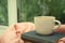 Cup of hot coffee, books and warm sweater on window sill indoors. Space for text