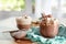 Cup with hot drink with marshmallows and cacao powder on table