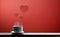 Cup of Hot drinks with stream, on red background with floating red hearts