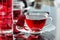 Cup of hot hibiscus tea (rosella, karkade) on kitchen table