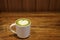 Cup of hot matcha green tea latte art drink for lover in valentine with heart shaped foam froth milk