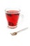 Cup with hot red carcade floral tea and teaspoon
