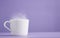 cup of hot tea or cade with purple background, on workbook