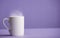 cup of hot tea or cade with purple background, on workbook