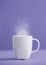 cup of hot tea or cade with purple background, on workbook