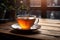 A cup of hot tea elegantly served on a wooden table, perfect for a relaxing afternoon.