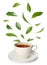 Cup of hot tea and falling green leaves on white background