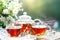 Cup with hot tea with mint and a thyme on a wooden table in a summer garden. Selective focus,