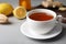 Cup of hot tea and natural cough remedies on table