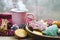 A cup of hot tea stands on a wooden table next to a wooden plate on which are gingerbread cookies made from orange slices against