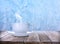 Cup of hot tea on table near window covered with frost