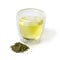 Cup of Japanese green tea and a heap of dried green tea leaves