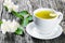 A cup of jasmine tea with jasmine flowers , close-up