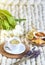 Cup with lavender tea, citrus and honey, croissant, white pastel giant knit blanket