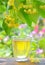 Cup with linden tea and flowers on wooden table