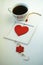 Cup of love, coffee with red heart. Red heart on a rope in the wooden frame. Valentine`s day. Morning. The 14th of February.