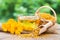 Cup of marigold tea and calendula flowers.