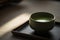 A cup of matcha green tea, served in a traditional Japanese ceramic cup. (Generative AI)