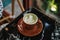 A cup of Matcha Latte with Latte Art on a black marble table