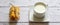 Cup of milk and breadstick on a wooden background. Healthy breakfast.