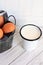 Cup of milk and  brown Eggs close up inside a bucket