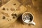 A Cup of milk and coffee beans on the serving wooden Board star anise, cinnamon and allspice.