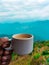 Cup of North Indian milk tea with hills in background in Darjeeling, India