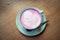 Cup of pink cappuccino in blue cup