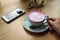 Cup of pink cappuccino in blue cup