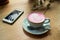 Cup of pink cappuccino in blue cup