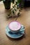 Cup of pink cappuccino in blue cup