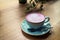 Cup of pink cappuccino in blue cup