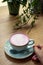 Cup of pink cappuccino in blue cup