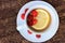 Cup with plate with half of lemon and group of ripe red raspberry on rough wooden table. Copy space. Healthy organic food theme.